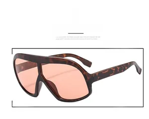 Detailed close-up of tortoise shell frame and orange translucent lenses on sunglasses