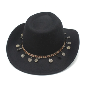Detail of ethnic western cowboy hat with woven band and vintage bronze coin charms