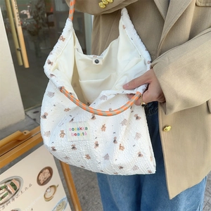 Detailed close-up of cartoon rabbit canvas tote with durable woven handle and magnetic snap