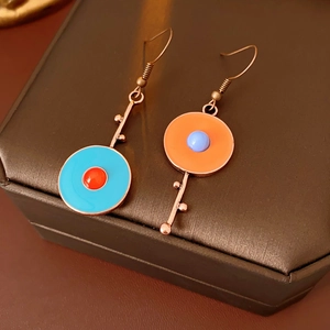 Detail view of vintage asymmetric enamel drop earrings with colorful geometric accents