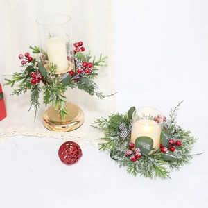 Detail of Christmas wreath candle holder with pine needles, berries and plaid bow