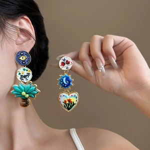 Artistic asymmetric gold drop earrings with colorful heart and eye enamel motifs