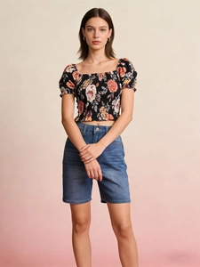 Floral puff sleeve crop top paired with high waist denim shorts on studio model