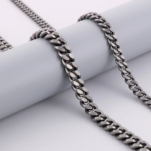 Detail of vintage gunmetal cuban link chain necklace wrapped on a display stand