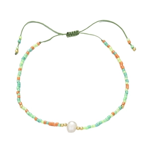 Bohemian style colorful bead bracelet featuring a white freshwater pearl and adjustable cord