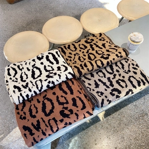 Detailed knit leopard pattern scarves in cream, khaki, caramel, and grey brown tones