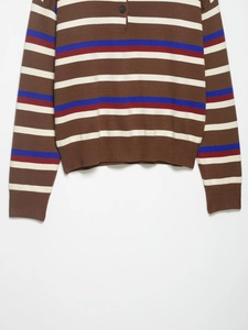 Detailed close-up of striped knit polo texture with brown, blue, and red patterns