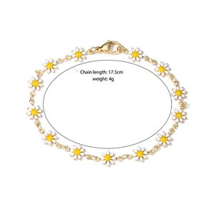 Golden daisy bracelet with white enamel petals, 17.5cm length and lobster clasp closure