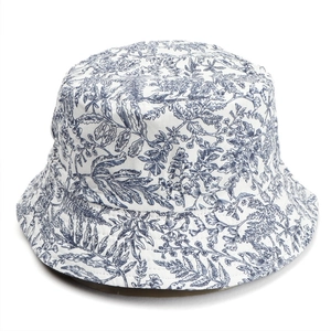 Detail of floral bucket hat featuring white and blue fern leaf pattern on cotton fabric