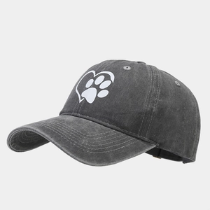 Close-up of heart and paw print on washed cotton baseball cap with vintage texture