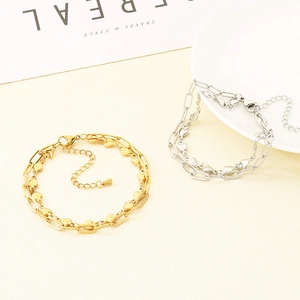 Detailed view of layered heart and oval link chains with lobster clasp in gold and silver
