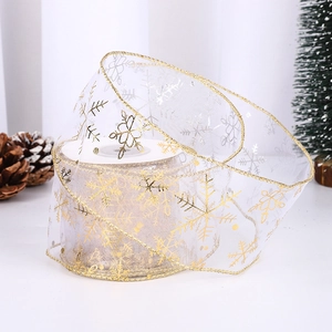 White translucent organza Christmas ribbon with golden snowflake prints for gift wrapping