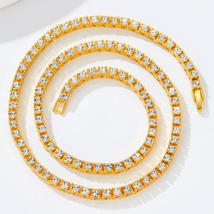 Detailed view of golden tennis chain necklace featuring round faceted cubic zirconia