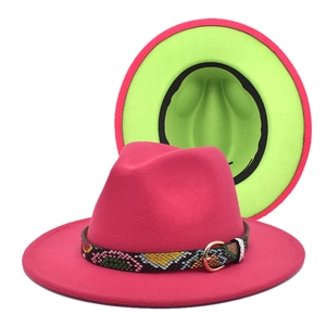Detail of two-tone fedora hat with rose red felt, neon green lining, and snakeskin band