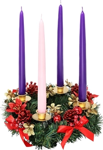Detailed view of Christmas wreath with purple and pink taper candles and red ribbons