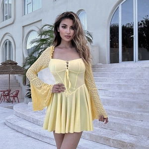 Detailed view of yellow lace sleeve and knit texture on this vintage party dress