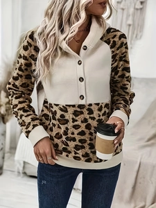 Detail of leopard print patchwork hoodie featuring four-button neckline and soft knit texture