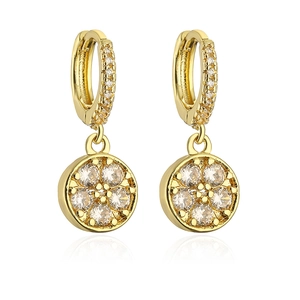 Macro detail of 18K gold plated hoop earrings with sparkling flower zircon pendant