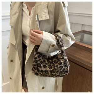 Close-up of plush leopard print tote bag with soft faux fur texture and zipper detail