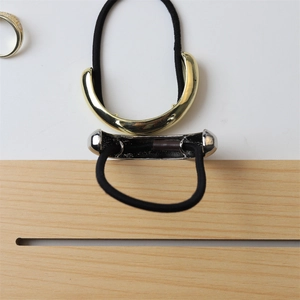 Detail of high-quality polished gold and silver metal hair ties with elastic bands