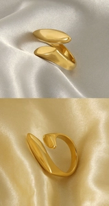 Macro detail of 18k gold plated geometric open ring with polished sculptural surface