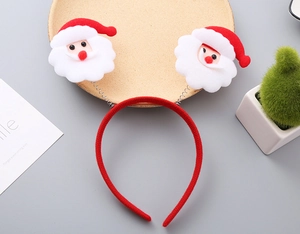 Detail of Christmas headband with Santa Claus spring boppers on wooden tray décor
