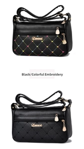 Detail of two black shoulder bags featuring colorful embroidery and heart-shaped quilting