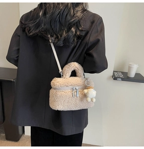Detail of beige faux shearling crossbody bag with cute bear pendant and matching strap
