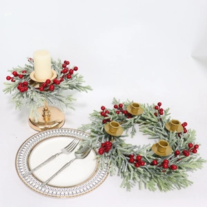 Frosted white pine needle candle ring with gold holders and festive red berries