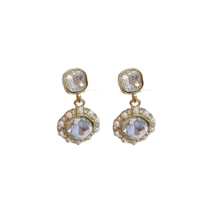 Vintage French gold earrings with square crystals and faux pearls on white background