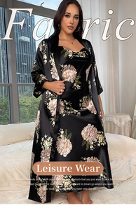 Detail of two-piece floral satin sleepwear set with long robe and slip dress in black