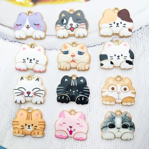 Detailed grid view of 12 colorful enamel cat charms made of gold plated alloy