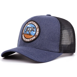 Detail view of Olympic National Park embroidery and breathable mesh on a retro trucker hat