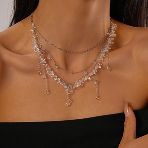 Detail of multi-layer silver fringe necklace with transparent resin flower beads