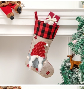 Christmas stocking with 3D gnome decoration hanging on a white fireplace mantel