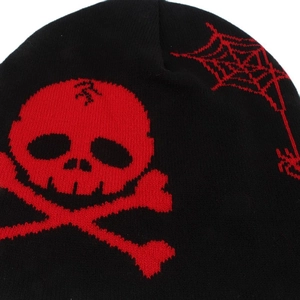 Close-up of red skull and crossbones with spider web patterns on black knitted beanie