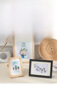Detail of minimalist solid wood photo frames in natural oak and black finishes with mats