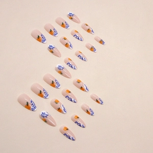 Chic long almond press-on nails featuring hand-painted orange fruit and blue leaf designs