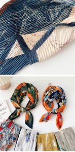 Detail of pleated silk scarves featuring assorted patterns and fine accordion textures