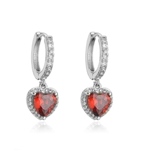 Close-up of heart-shaped red gemstone earrings with silver diamond halo and hoop clasp