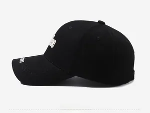 Detailed side view of black cotton baseball cap featuring white 3D letter embroidery