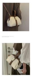 Detail view of contrast color doctor bag with retro clasp and adjustable crossbody strap