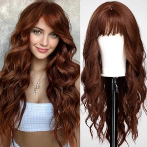 Detail view of long wavy reddish-brown wig with bangs on model and mannequin head