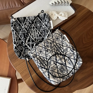 Retro embroidered canvas crossbody bag with geometric patterns in black and white