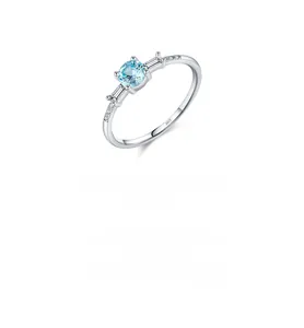 Close-up of S925 silver ring featuring light blue round stone and emerald-cut diamonds