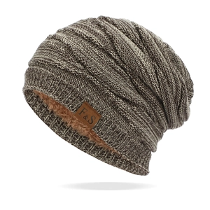 Detail shot of winter knit beanie showing the warm brown fleece lining and logo patch
