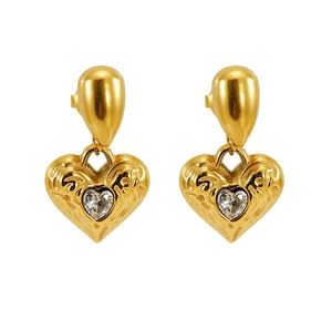 Detail of gold-plated heart earrings with hammered texture and sparkling zircon stone