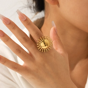 Close-up of polished 18k gold plated stainless steel sunflower ring on model finger