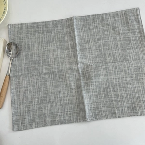 Detailed view of the woven gray and white cotton linen placemat with rustic texture