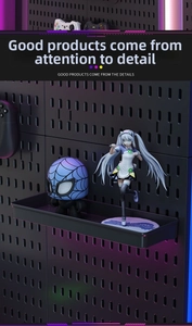 Macro detail of black pegboard with modular shelf in a neon gaming room setup